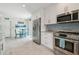 Modern kitchen features stainless steel appliances, white cabinets, and stylish backsplash at 11315 N Armenia Ave, Tampa, FL 33612