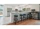 Bright kitchen with stainless appliances, bar seating, and a desk in the corner at 11315 N Armenia Ave, Tampa, FL 33612