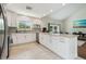 Bright, open kitchen with bar seating and adjacent living area at 11315 N Armenia Ave, Tampa, FL 33612