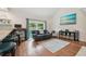 Cozy living room with wood floors, vaulted ceilings, and sliding glass doors to the yard at 11315 N Armenia Ave, Tampa, FL 33612