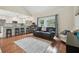 Cozy living room with wood floors, an adjacent kitchen, and lots of natural light at 11315 N Armenia Ave, Tampa, FL 33612