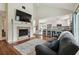 Spacious living room with fireplace, TV, and an open layout leading to the kitchen at 11315 N Armenia Ave, Tampa, FL 33612