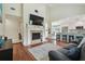Open-concept living room with a fireplace, TV, and a view of the kitchen and dining area at 11315 N Armenia Ave, Tampa, FL 33612