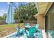 Covered patio features a seating area, a fire pit, and an umbrella at 11315 N Armenia Ave, Tampa, FL 33612