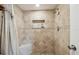 Walk-in shower with tile surround, corner seat and recessed shelf at 11315 N Armenia Ave, Tampa, FL 33612