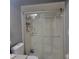 Bathroom featuring sliding glass shower doors and black and white tile flooring at 11511 113Th St # 5C, Largo, FL 33778
