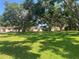 Lush community green space with mature trees and manicured lawn creating a serene setting at 11511 113Th St # 5C, Largo, FL 33778