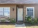 Charming townhouse featuring a welcoming front door and decorative window details at 11511 113Th St # 5C, Largo, FL 33778