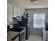 Bright kitchen features white cabinets, stainless steel appliances, and a patterned ceiling at 11511 113Th St # 5C, Largo, FL 33778