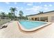 Community pool with ample seating and a covered lounge area at 11511 113Th St # 5C, Largo, FL 33778