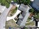 An overhead view of a single Gathering home with manicured front yard and winding driveway at 116 S Arrawana Ave, Tampa, FL 33609