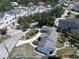 An aerial view of a neighborhood of multi-Gathering homes and mature trees at 116 S Arrawana Ave, Tampa, FL 33609