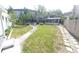 Large backyard featuring mature trees, a pathway, and a screened-in patio at 116 S Arrawana Ave, Tampa, FL 33609