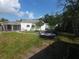 Spacious backyard with a patio, perfect for outdoor entertaining or relaxing under the trees at 116 S Arrawana Ave, Tampa, FL 33609