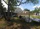 A spacious backyard featuring a concrete patio, trees and partial fencing at 116 S Arrawana Ave, Tampa, FL 33609