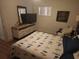 Bright bedroom featuring a comfy bed, wooden floors, and a dresser with mounted television at 116 S Arrawana Ave, Tampa, FL 33609