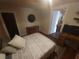 Small bedroom featuring a comfy bed, wood floors, and dresser at 116 S Arrawana Ave, Tampa, FL 33609