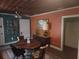 Cozy dining room featuring hardwood floors, colorful artwork, and vintage furniture at 116 S Arrawana Ave, Tampa, FL 33609
