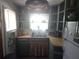 Quaint kitchen with light wood counters, open shelving, stainless sink, and a Tiffany-style pendant light at 116 S Arrawana Ave, Tampa, FL 33609