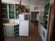 A kitchen featuring green cabinetry, wood counters, and an eat-in area at 116 S Arrawana Ave, Tampa, FL 33609