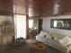 This living room features hardwood floors, natural light, and a view into an adjacent room with a dining table at 116 S Arrawana Ave, Tampa, FL 33609