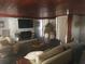 Bright living room with stone fireplace and hardwood flooring at 116 S Arrawana Ave, Tampa, FL 33609