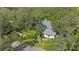 Aerial view of home showcasing its sprawling lot surrounded by lush greenery and mature trees at 12002 Hope Ln, Tampa, FL 33618