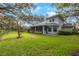 Expansive backyard with lush green lawn and a screened-in porch at 12002 Hope Ln, Tampa, FL 33618
