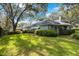 Backyard with lush green lawn, privacy landscaping and large trees at 12002 Hope Ln, Tampa, FL 33618