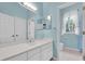 Bright bathroom featuring a white vanity, ample mirror, and a separate toilet room at 12002 Hope Ln, Tampa, FL 33618