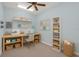 Bright craft room features desk, shelving, storage baskets, sewing machine, and light blue walls, creating inspiring space at 12002 Hope Ln, Tampa, FL 33618