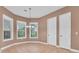 Inviting dining room with tile flooring, bright windows, and a modern chandelier at 12002 Hope Ln, Tampa, FL 33618