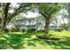 Beautiful two-story home with manicured landscaping and mature trees offering shade and curb appeal at 12002 Hope Ln, Tampa, FL 33618