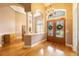 Elegant foyer featuring a chandelier, wood floors and double doors at 12002 Hope Ln, Tampa, FL 33618