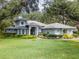 Stunning single-Gathering home featuring a lush lawn, mature trees and meticulous landscaping at 12002 Hope Ln, Tampa, FL 33618