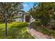 Charming two-story home with beautiful landscaping and a brick walkway at 12002 Hope Ln, Tampa, FL 33618