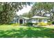 Charming single-Gathering home with a well-manicured lawn and mature trees at 12002 Hope Ln, Tampa, FL 33618