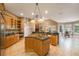 Expansive kitchen with tile floors, granite counters, wood cabinets, a kitchen island, and open access to the living spaces at 12002 Hope Ln, Tampa, FL 33618