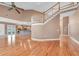 Spacious living room featuring hardwood floors, staircase, and seamless flow into the kitchen area at 12002 Hope Ln, Tampa, FL 33618