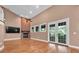 Bright living room with hardwood floors, a brick fireplace, a ceiling fan, and French doors at 12002 Hope Ln, Tampa, FL 33618