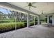 Covered outdoor patio with brick flooring and a beautiful view of the backyard's landscaping at 12002 Hope Ln, Tampa, FL 33618