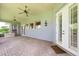 Covered outdoor patio with ceiling fans, brick flooring and views of the exterior grounds at 12002 Hope Ln, Tampa, FL 33618