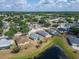 Aerial view highlighting homes in a vibrant community, nestled near a peaceful lake and lush trees at 12119 Buffington Ln, Riverview, FL 33579