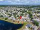 Aerial shot of a lakeside community highlighting home's location with a distinct red marker at 12119 Buffington Ln, Riverview, FL 33579