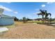 Large backyard with waterfront views, featuring a patio and palm trees at 12119 Buffington Ln, Riverview, FL 33579