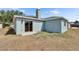 Backyard of home featuring a sliding door, chimney and light blue siding at 12119 Buffington Ln, Riverview, FL 33579