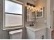 The bathroom showcases a white vanity with black hardware and a rectangular mirror over the sink, offering a modern aesthetic at 12119 Buffington Ln, Riverview, FL 33579