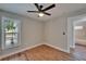 Bedroom featuring wood-look flooring, neutral walls, and a ceiling fan for a comfortable ambiance at 12119 Buffington Ln, Riverview, FL 33579