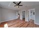 Spacious bedroom boasts wood floors, ceiling fan and multiple doors to en-suite bath and walk-in closet at 12119 Buffington Ln, Riverview, FL 33579