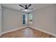 Bright bedroom featuring wood-look flooring and two windows providing plenty of natural light at 12119 Buffington Ln, Riverview, FL 33579
